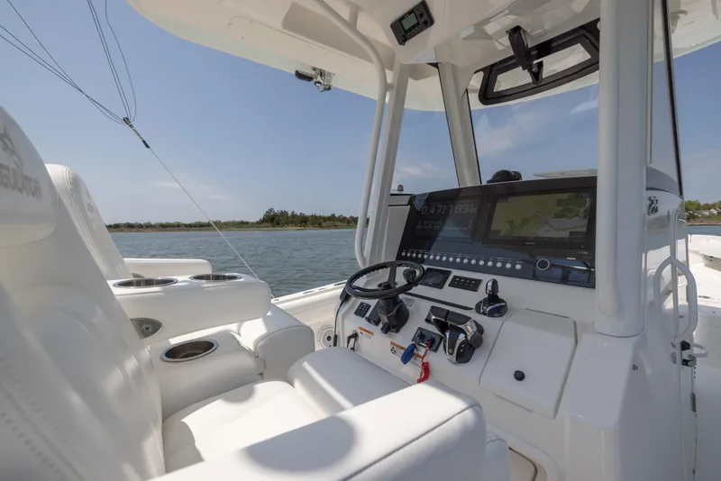 Slide: The Image of 2021 Regulator 28FS boat dashboard with steering wheel and navigation controls. - 16