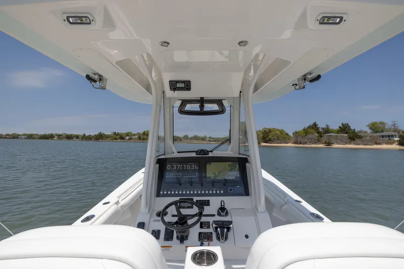 Slide: The Image of 2021 Regulator 28FS boat cockpit with modern navigation system on calm water. - 18