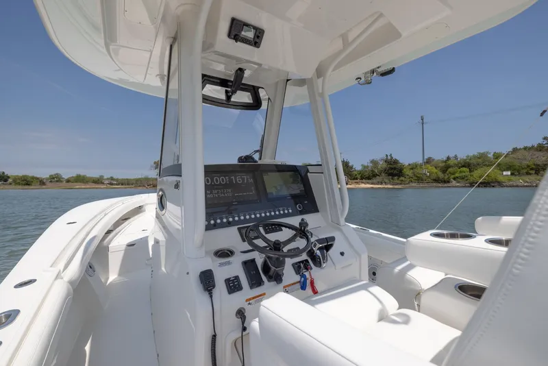 Slide: The Image of 2021 Regulator 28FS boat console with navigation system on calm water. - 19
