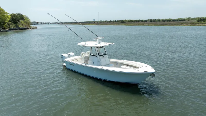 Slide: The Image of 2021 Regulator 28FS boat on calm water, featuring a spacious deck and modern design. - 26