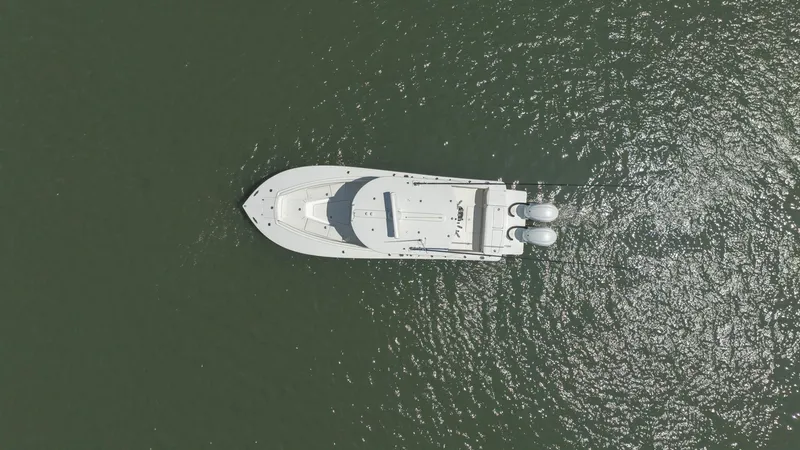 Slide: The Image of 2021 Regulator 28FS boat docked in marina with Yamaha outboard engine. - 4