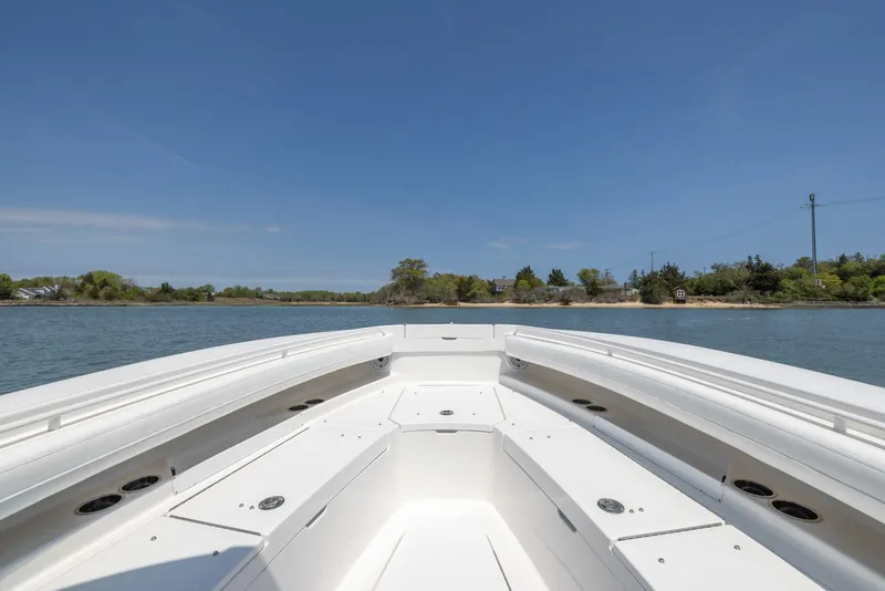 Slide: The Image of 2021 Regulator 28FS boat with dual engines cruising on a calm waterway. - 8