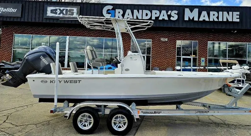 Slide: The Image of 2025 Key West 210 BR boat on trailer at Grandpa's Marine dealership. - 2