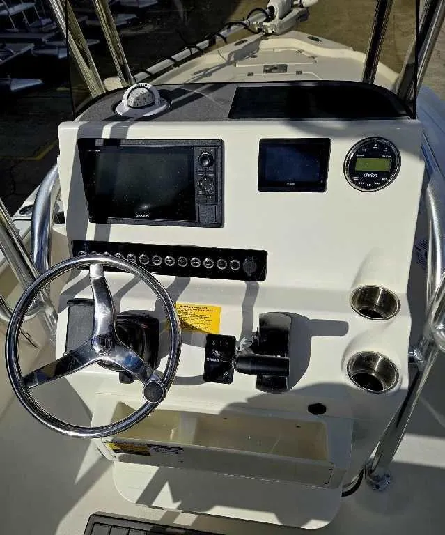 Slide: The Image of Control panel of 2025 Key West 210 BR boat with steering wheel and navigation instruments. - 6