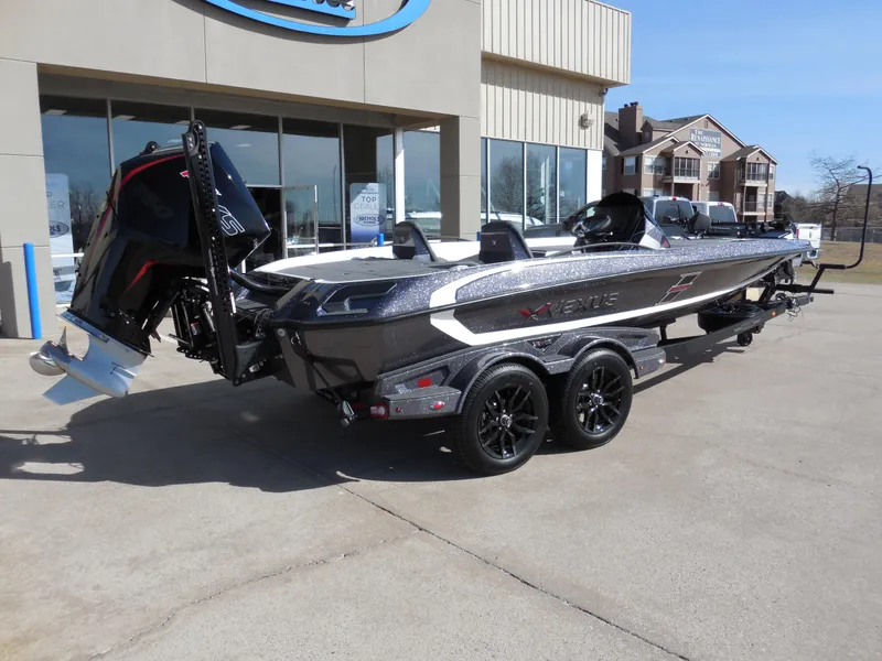 Slide: The Image of 2025 Vexus VXS 21 boat on trailer outside dealership, showcasing sleek design and powerful engine. - 3