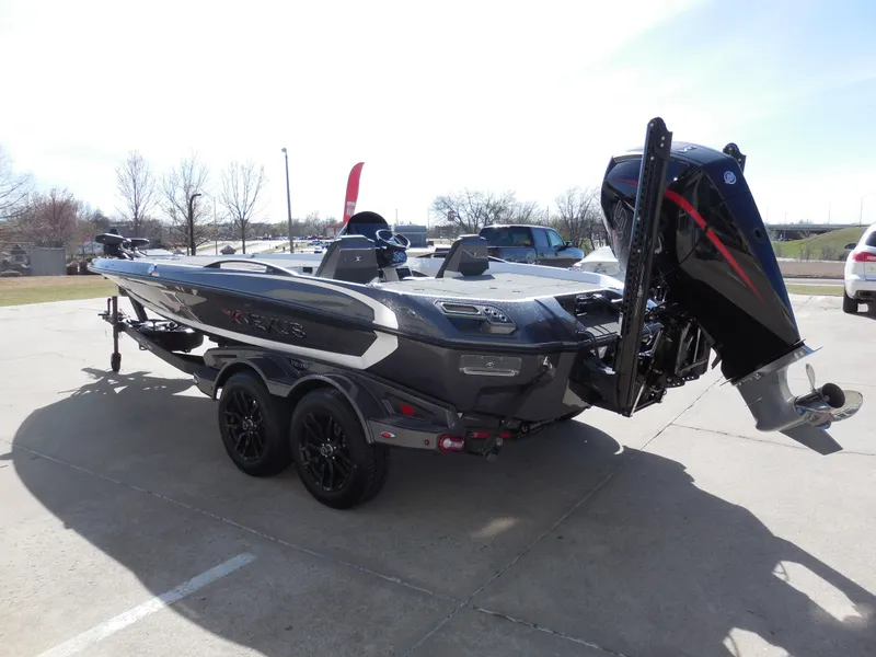 Slide: The Image of 2025 Vexus VXS 21 boat on trailer, sleek design, powerful outboard motor, parked outdoors. - 4