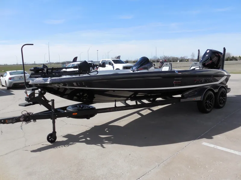 Slide: The Image of 2025 Vexus VXS 21 boat on trailer, parked outdoors under clear sky. - 5