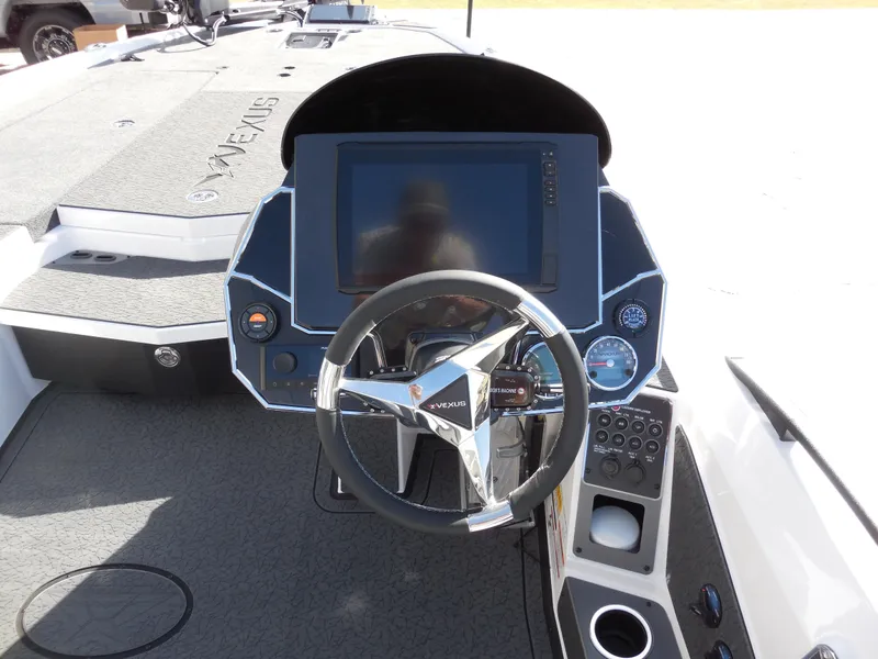 Slide: The Image of 2025 Vexus VXS 21 boat dashboard with steering wheel and digital display. - 9