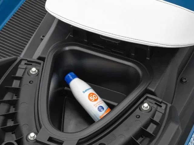 Slide: The Image of 2024 Yamaha VX Cruiser® storage compartment with sunscreen bottle. - 4