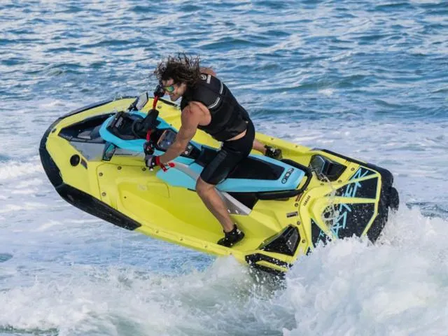 Slide: The Image of 2025 Yamaha Waverunner Jetblaster performing a jump over ocean waves. - 11