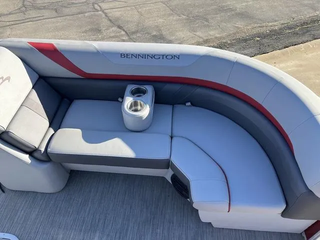 Slide: The Image of Bennington 23 SSBX 2022 boat seating with cup holders, gray and red upholstery. - 10