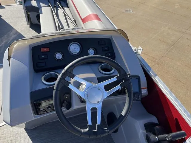 Slide: The Image of Steering console of 2022 Bennington 23 SSBX boat with gauges and cup holders. - 12