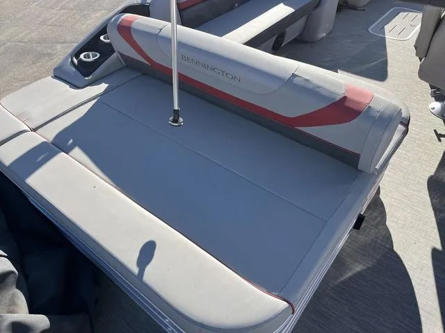 Slide: The Image of 2022 Bennington 23 SSBX boat interior with gray and red seating. - 3