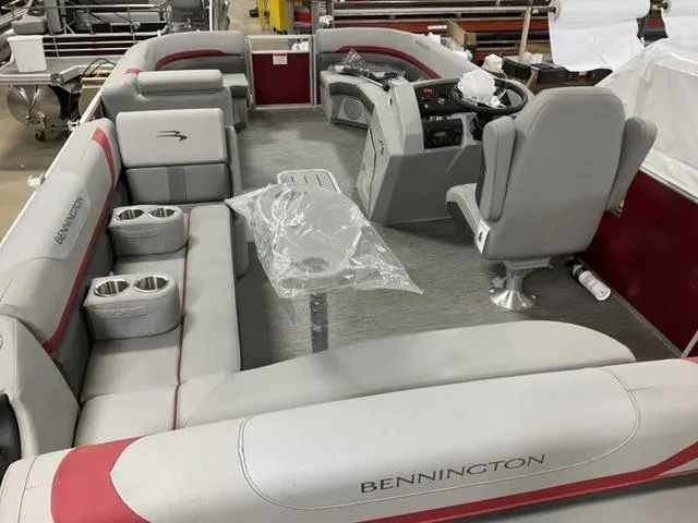 Slide: The Image of 2022 Bennington 23 SSBX pontoon boat interior with gray seating and red accents. - 6
