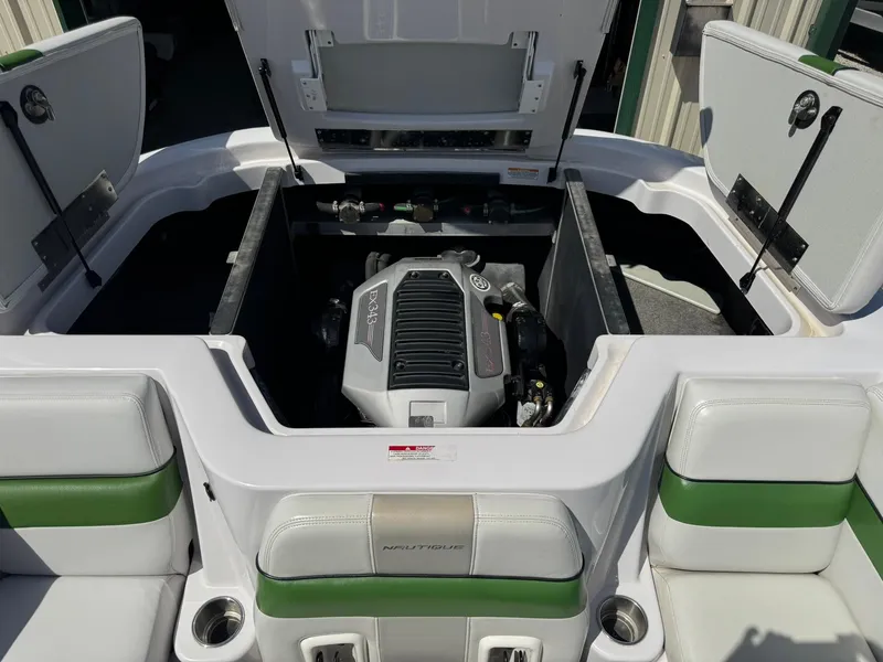 Slide: The Image of 2008 Nautique Super Air 220 boat engine compartment with open hatches and seating. - 10