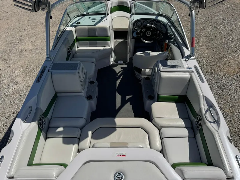 Slide: The Image of 2008 Nautique Super Air 220 boat interior with white and green seating. - 12