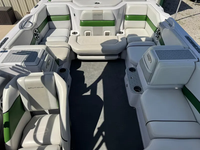 Slide: The Image of 2008 Nautique Super Air 220 boat interior with green and white seating. - 16