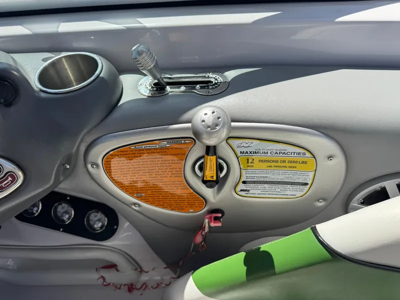 Slide: The Image of 2008 Nautique Super Air 220 boat dashboard with controls and capacity labels. - 21