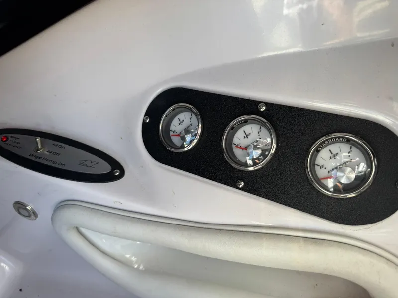 Slide: The Image of 2008 Nautique Super Air 220 dashboard with gauges and controls. - 22