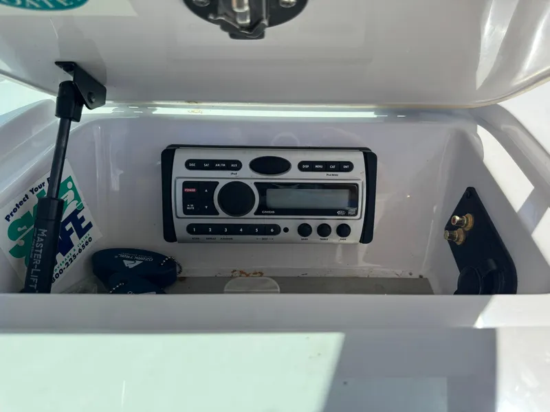 Slide: The Image of 2008 Nautique Super Air 220 boat stereo system in a storage compartment. - 23