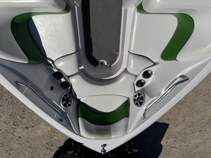 Slide: The Image of 2008 Nautique Super Air 220 boat interior with green and white seating, cup holders, and speakers. - 24