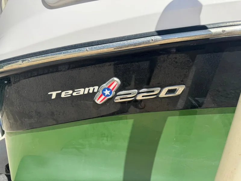 Slide: The Image of 2008 Nautique Super Air 220 boat with "Team 220" logo on green and black hull. - 6