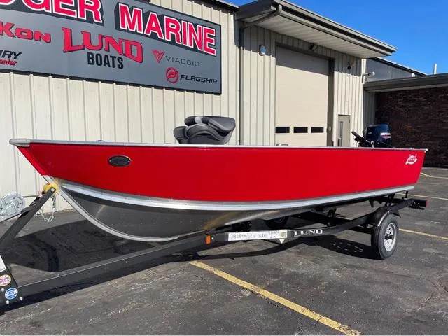 Slide: The Image of 2025 Lund Fury 1600 Tiller Heritage Edition boat in vibrant red on a trailer. - 3