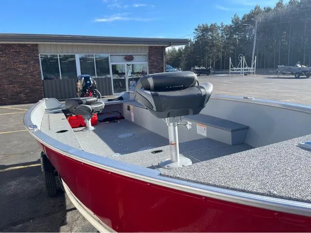 Slide: The Image of 2025 Lund Fury 1600 Tiller Heritage Edition boat, red exterior, parked outdoors. - 5