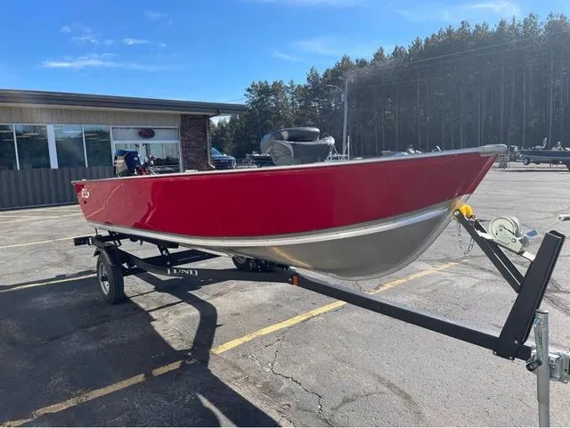 Slide: The Image of 2025 Lund Fury 1600 Tiller Heritage Edition boat on trailer, red and silver design. - 6