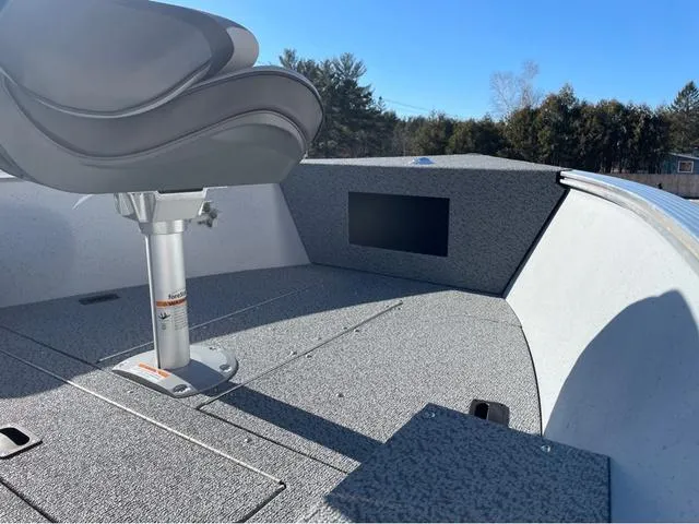 Slide: The Image of 2025 Lund Fury 1600 Tiller Heritage Edition boat interior with swivel seat and carpeted deck. - 7