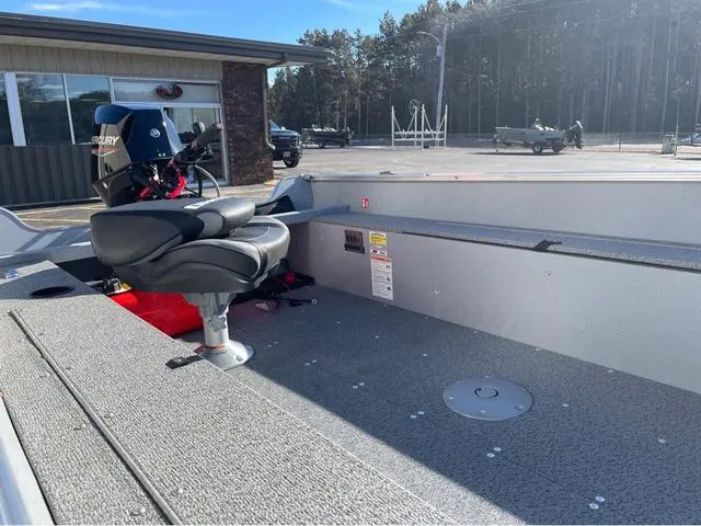 Slide: The Image of 2025 Lund Fury 1600 Tiller Heritage Edition boat interior with seating and motor. - 8