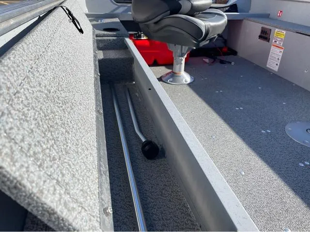 Slide: The Image of 2025 Lund Fury 1600 Tiller Heritage Edition interior with seating and storage compartments. - 9