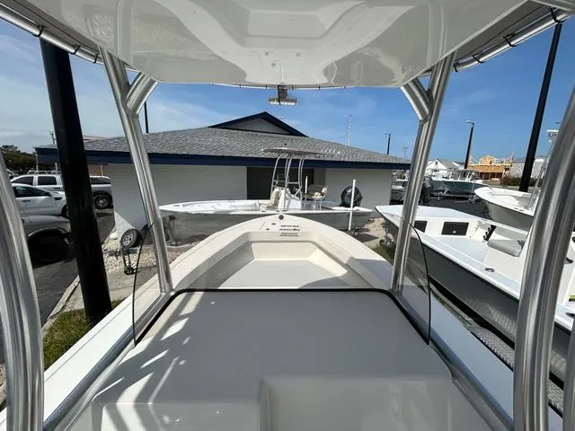 Slide: The Image of 2025 May-Craft 2000 Cape Classic boat, docked, with T-top and spacious deck. - 11