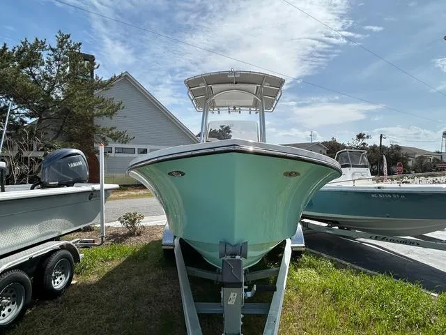 Slide: The Image of 2025 May-Craft 2000 Cape Classic boat on trailer, parked outdoors under clear sky. - 4
