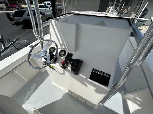Slide: The Image of 2025 May-Craft 2000 Cape Classic boat console with steering wheel and controls. - 9