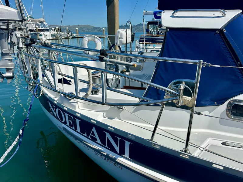 Slide: The Image of Valiant 39 sailboat "Noelani" docked, 1996 model, with blue accents and stainless steel railings. - 10