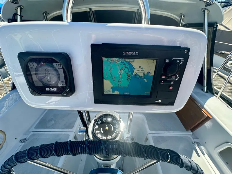 Slide: The Image of Steering console of 1996 Valiant 39 sailboat with navigation instruments and compass. - 17