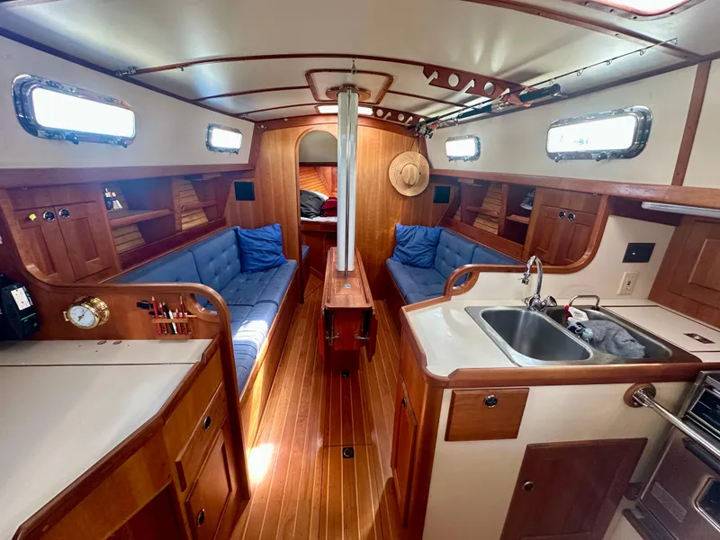 Slide: The Image of Interior of a 1996 Valiant 39 sailboat with wood finish and blue seating. - 24