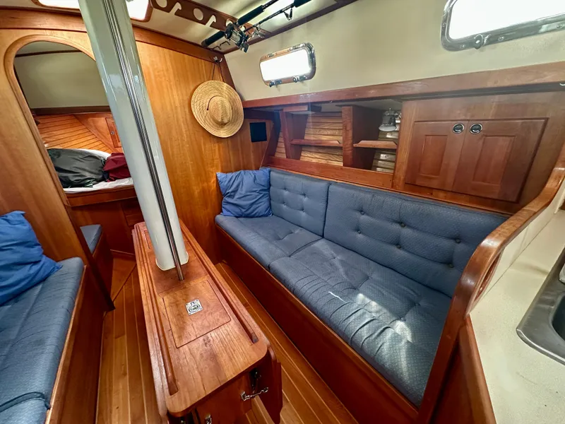 Slide: The Image of Cozy interior of 1996 Valiant 39 sailboat with wooden furnishings and blue cushions. - 25