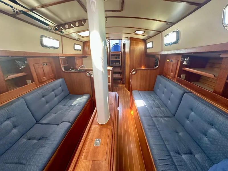 Slide: The Image of Spacious interior of 1996 Valiant 39 sailboat with wooden finish and blue seating. - 26