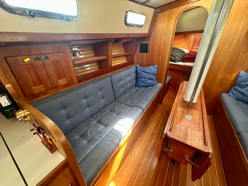 Slide: The Image of Interior of a 1996 Valiant 39 sailboat with wooden furnishings and blue cushions. - 28