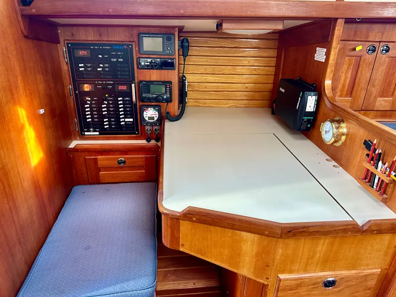 Slide: The Image of Navigation station in a 1996 Valiant 39 sailboat with control panel and seating. - 29