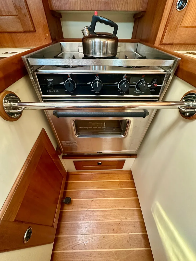 Slide: The Image of 1996 Valiant 39 yacht kitchen with stove, oven, and kettle. - 31