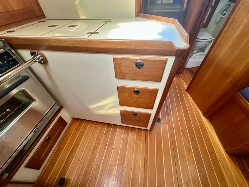Slide: The Image of 1996 Valiant 39 yacht interior with wooden cabinetry and flooring. - 32