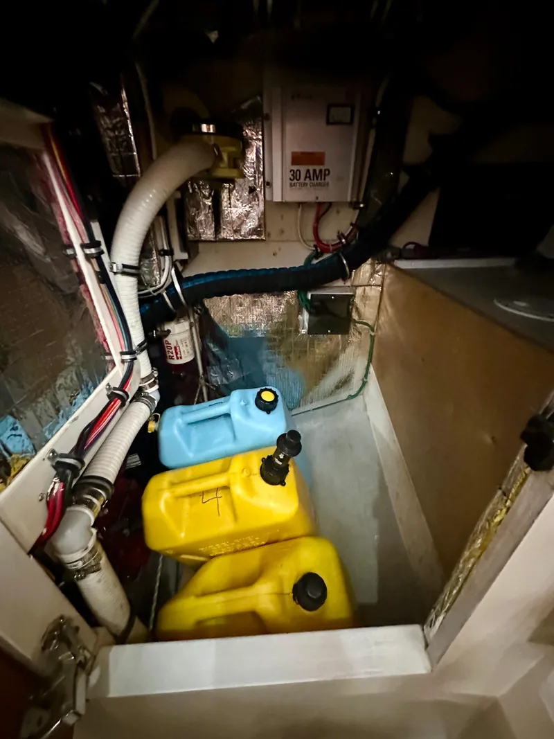 Slide: The Image of Engine compartment of a 1996 Valiant 39 with fuel containers and electrical components. - 42