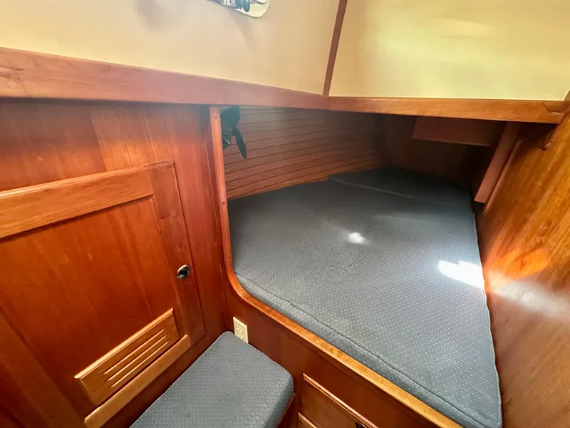Slide: The Image of Cozy wooden cabin interior of 1996 Valiant 39 sailboat with cushioned sleeping area. - 46