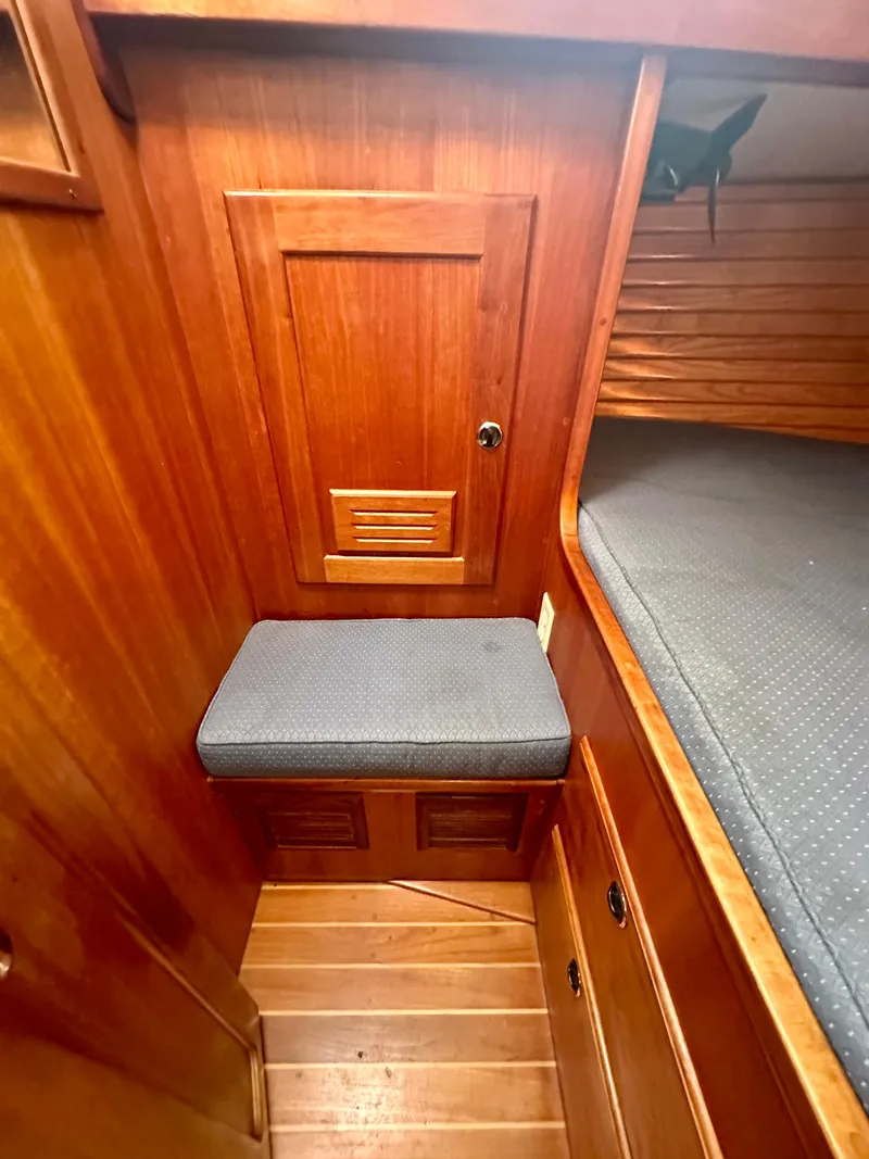 Slide: The Image of 1996 Valiant 39 interior cabin with wooden paneling and cushioned seating. - 48