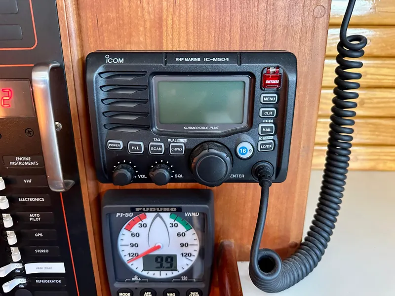 Slide: The Image of VHF marine radio and wind gauge on a 1996 Valiant 39 sailboat dashboard. - 51