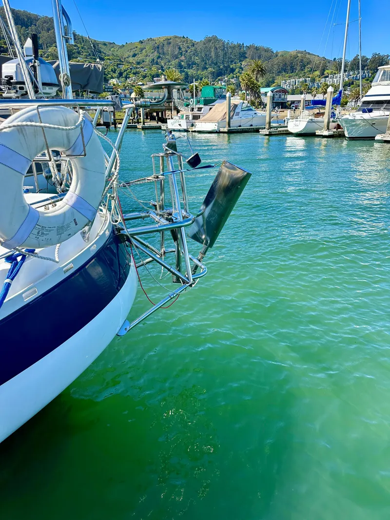 Slide: The Image of Sailboat Valiant 39 (1996) docked in a marina with clear green water. - 7