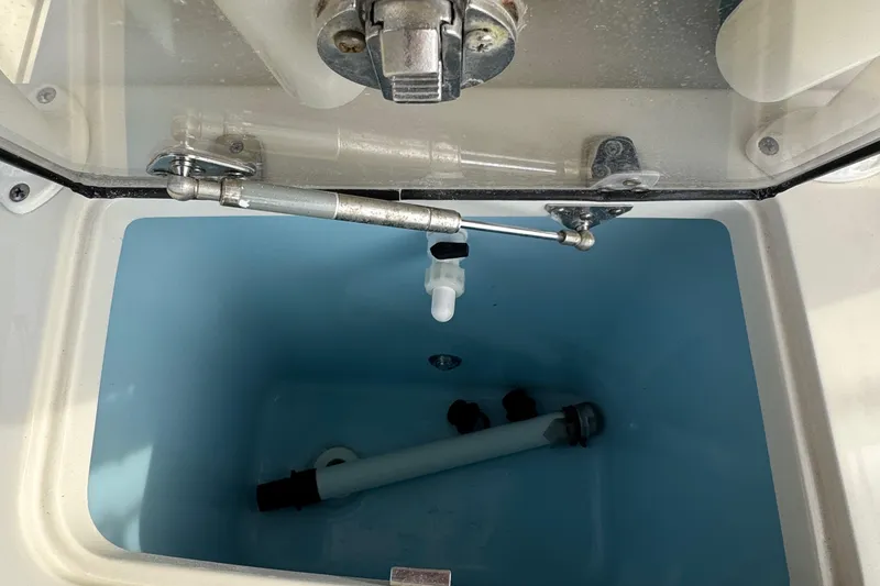 Slide: The Image of 2015 Chris-Craft Catalina 29 livewell with open lid and visible plumbing components. - 11